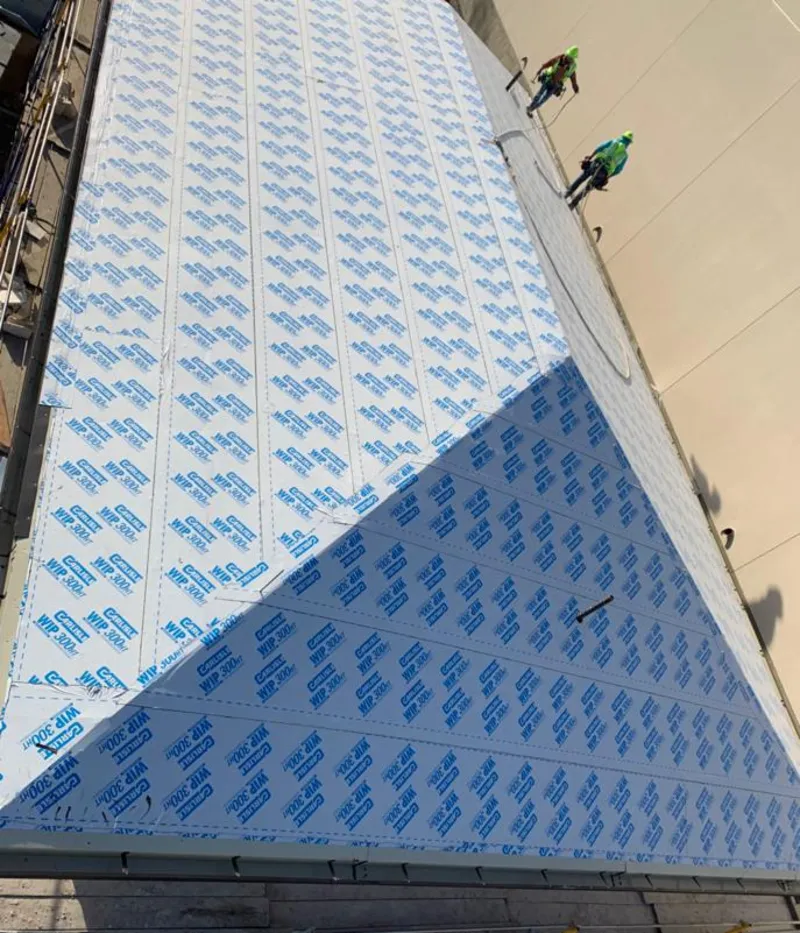 Professional roofers installing underlayment on a metal roof in Montpelier